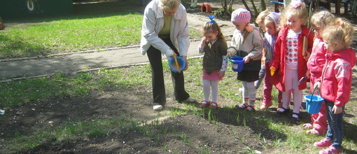 Діточки групи №7 залюбки допомагають вихователю на городі.